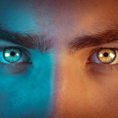 a man's face with two different colored eyes