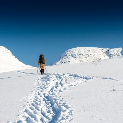 a person walking across a snow covered field