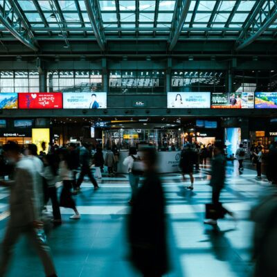 a group of people walking through a train station